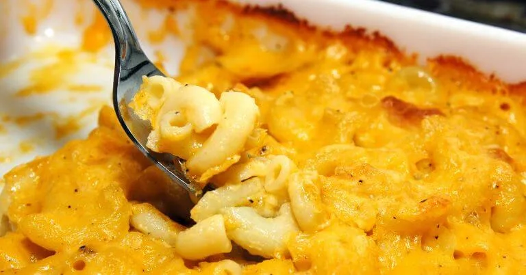 Spoonful of baked macaroni and cheese with a golden top.
